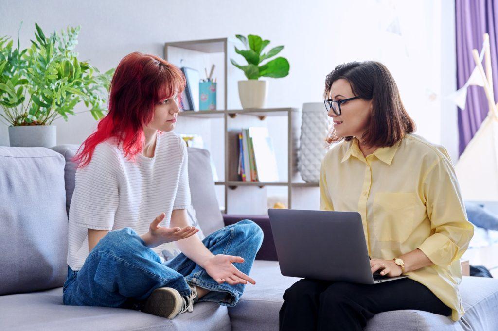 Therapy session for teenage girl, psychologist and patient together in office at Saving My Tomorrow